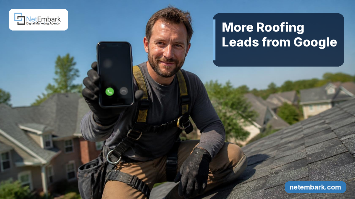 A smiling roofer in a safety harness and work gloves kneels on a dark asphalt-shingle roof of a suburban home on a sunny day, holding up a smartphone that shows an incoming call. A navy panel reads "More Roofing Leads from Google". The Netembark logo sits on a white chip in the top-left corner, and "netembark.com" is in the bottom-right corner.
